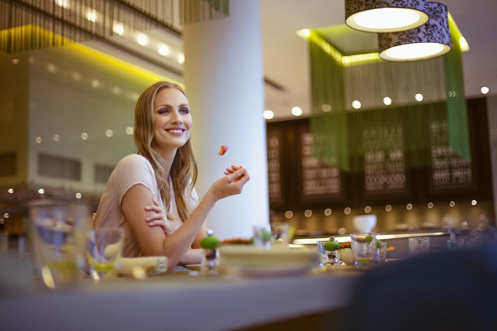 Downtown Rotana Hotel Al-Manamah Bagian luar foto A woman at a restaurant